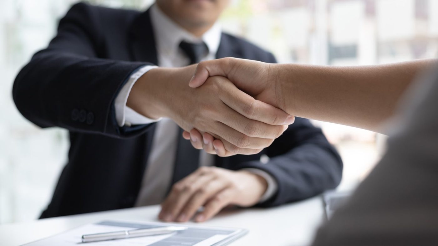 Recruiter shaking hands with a candidate after an interview