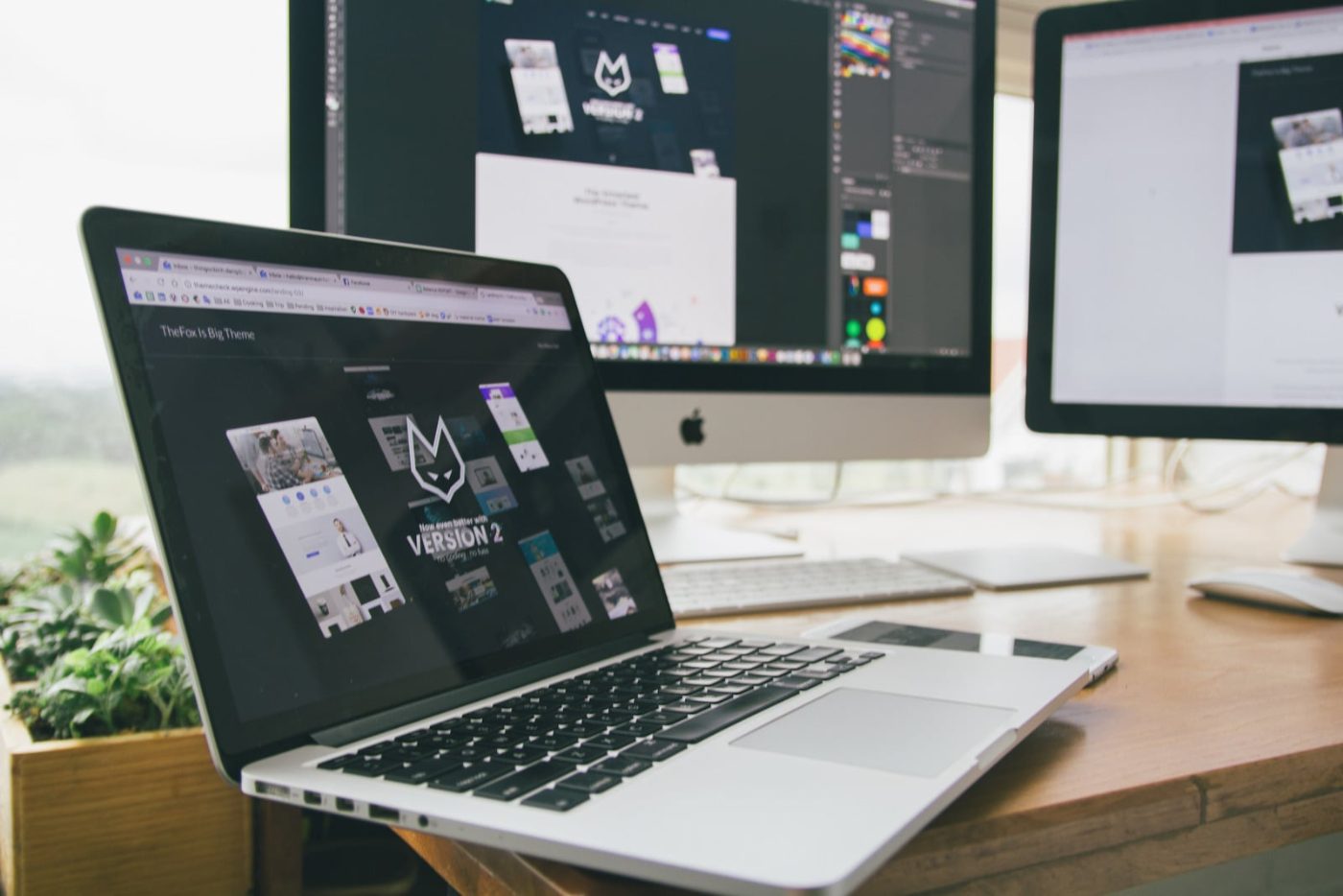 Laptop and monitors showing responsive website designs
