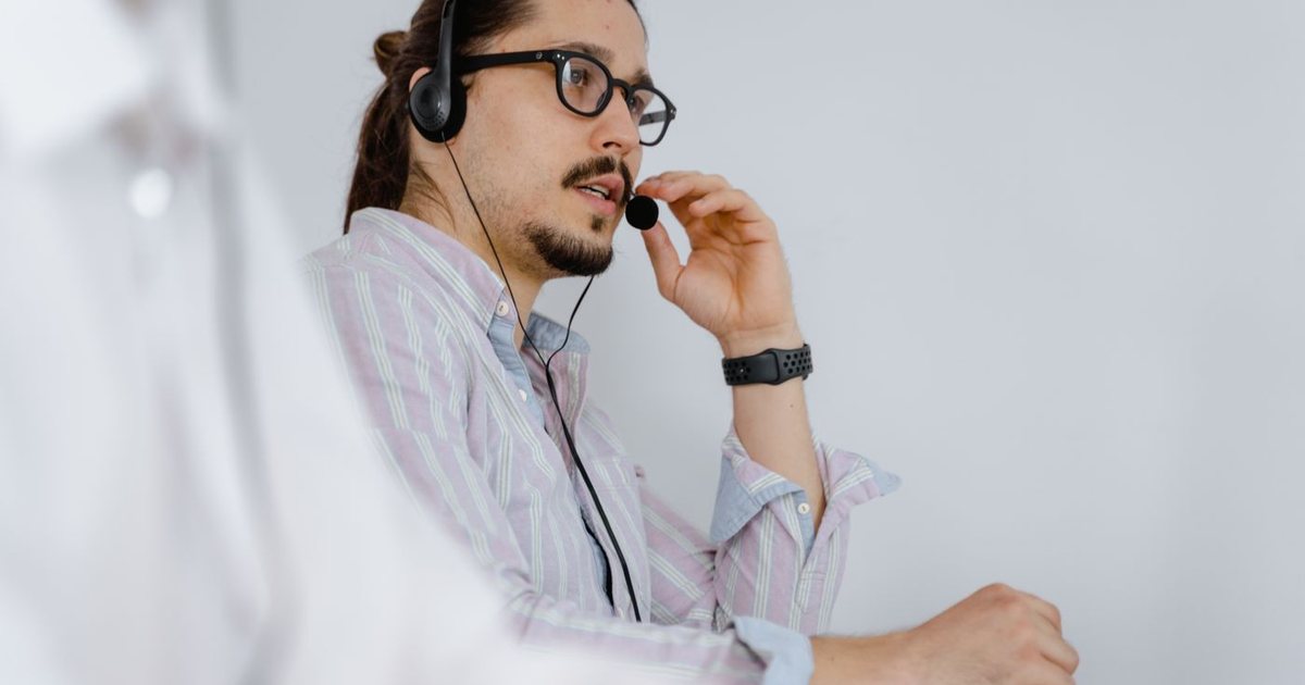 Call centre agent with a headset taking a call