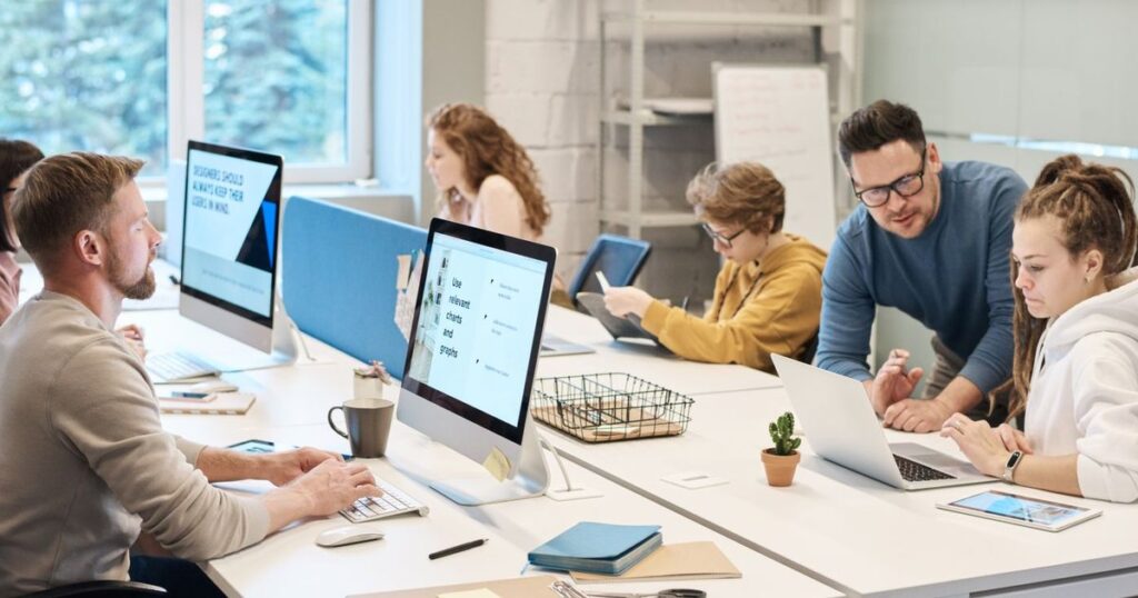 Team working at computers in a bright open office