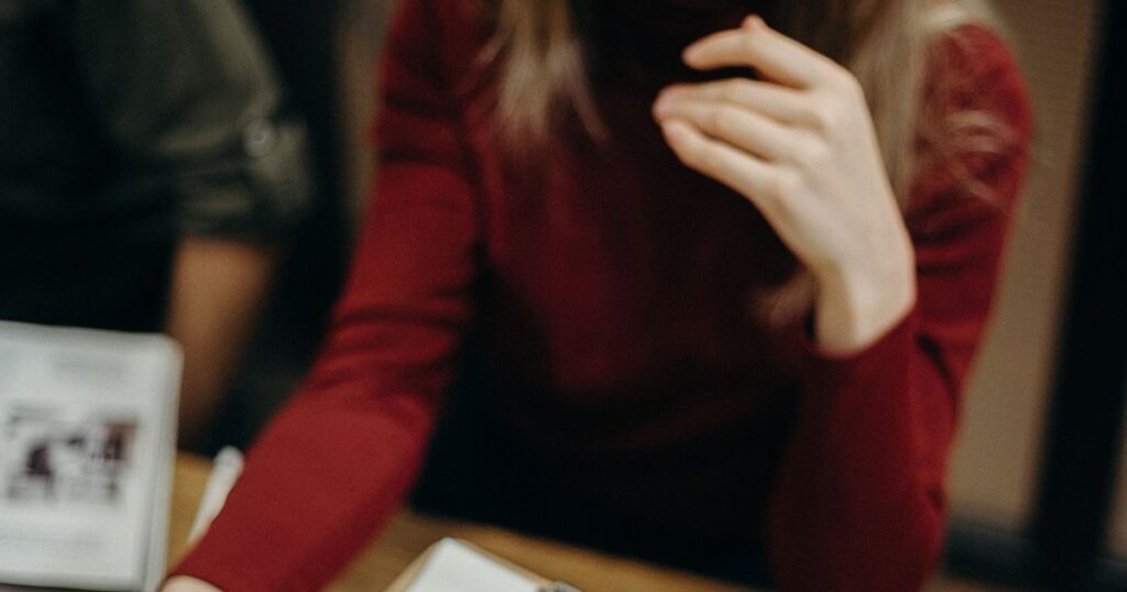 Recruiter reviewing a candidate's details on a clipboard